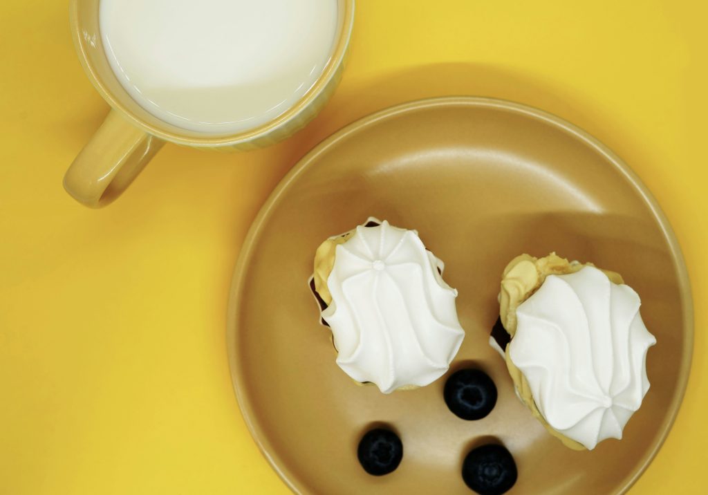 a plate of food and a cup of milk