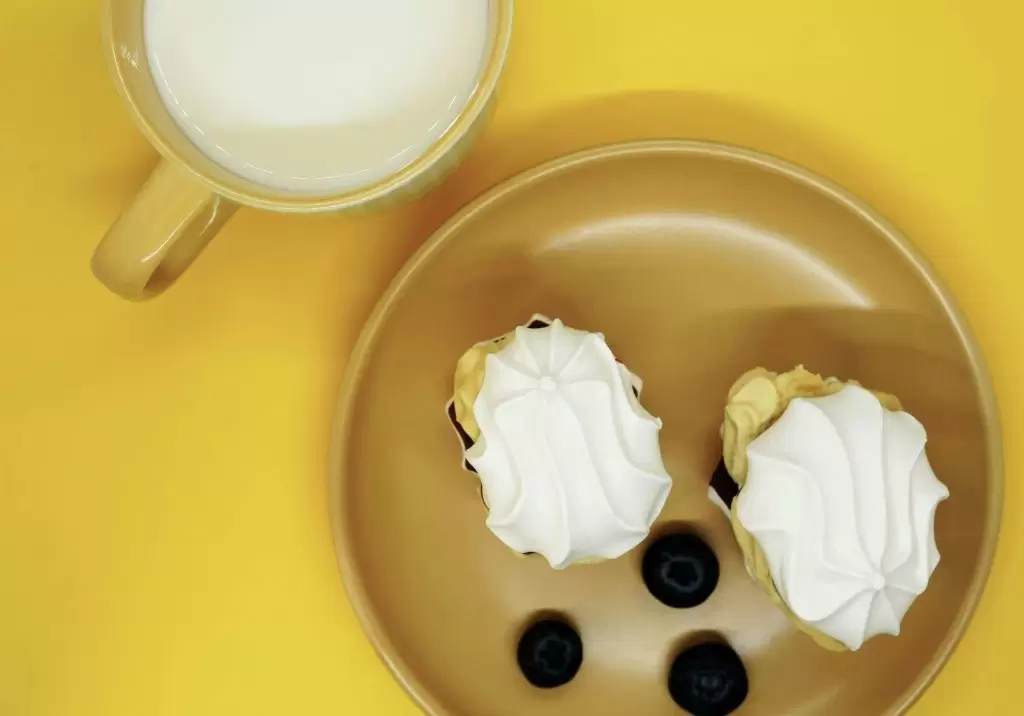 a plate of food and a cup of milk